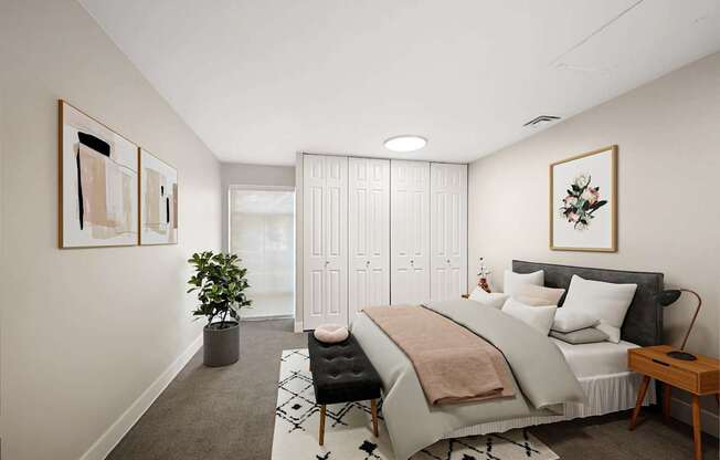 A bedroom with a large bed and a potted plant.