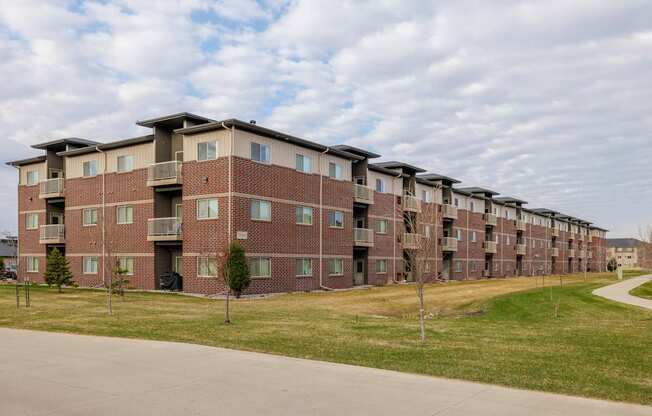 Apartment building with a green lawn in front.