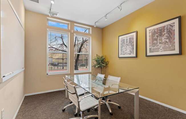 A conference room with a glass table and chairs.
