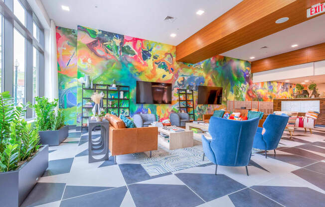 a lobby with a colorful mural on the wall and a checkered floor