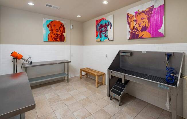 A room with a bench, a table, and two paintings on the wall.
