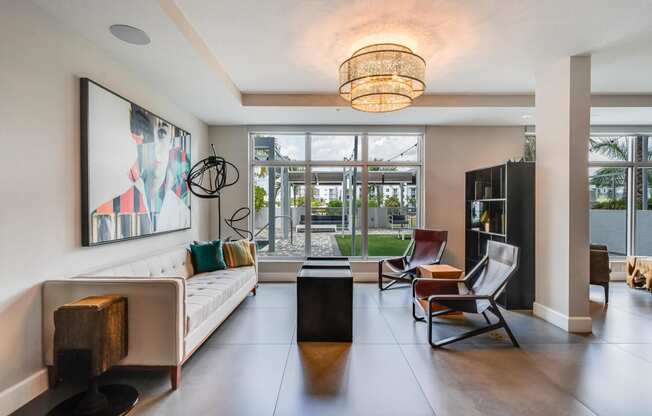 a living room with a white couch and a large window