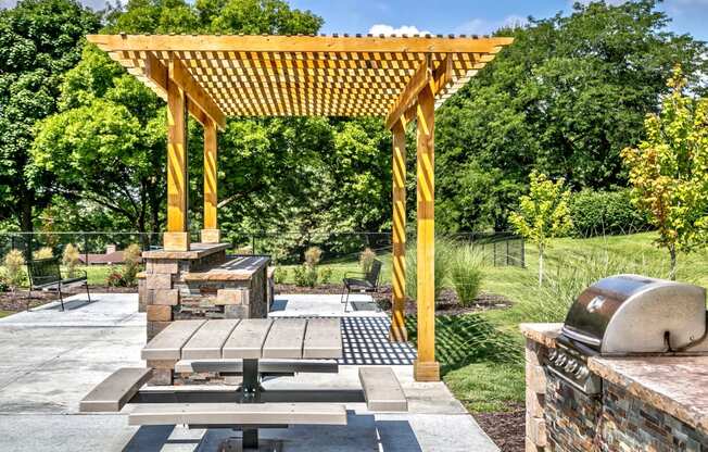 Outdoor picnic area with community grills and fireplaces at Club at Highland Park Apartments, Omaha, NE