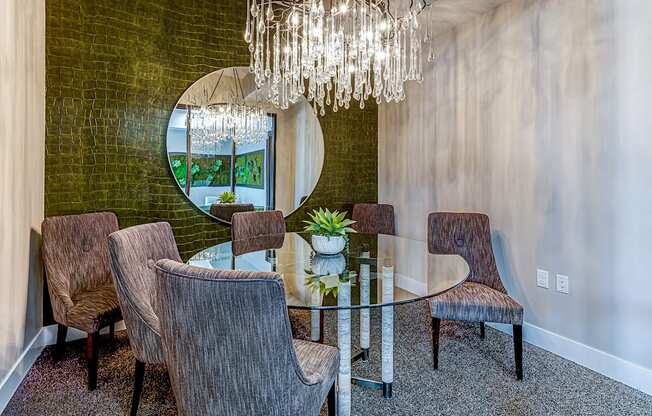 A dining room with a glass table and chairs.