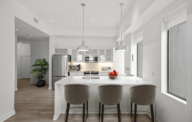 A modern kitchen with a dining table and chairs.