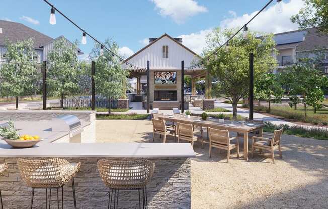 Outdoor kitchen with tables at The Howard Apartments in Manor, Texas