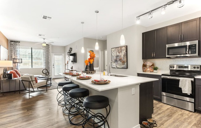 a kitchen with a large island with bar stools