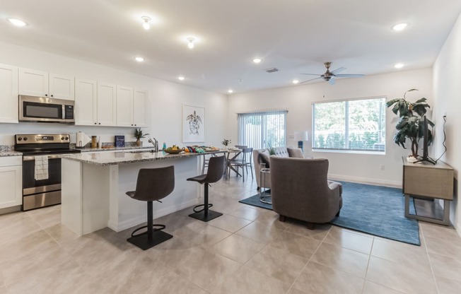 Boatman Hammock Townhomes in Lake Worth, FL photo of a living room with a kitchen and a dining room