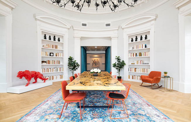 a dining room with a table and chairs and bookshelves
