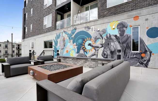 A mural of a man on a horse is painted on the side of a building.