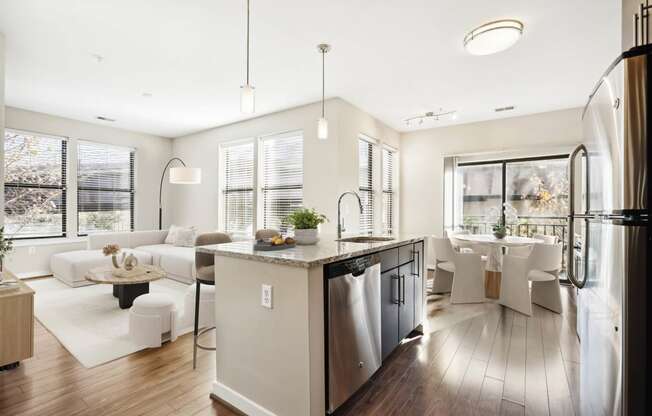 a white living room with a kitchen and a dining room