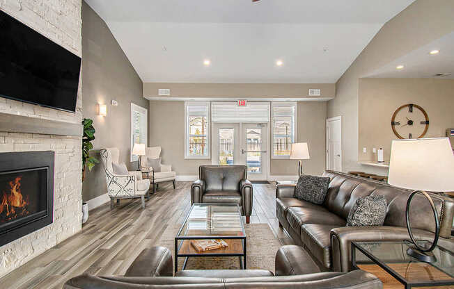 Posh Lounge Area With Fireplace In Clubhouse at Strathmore Apartment Homes, West Des Moines, Iowa