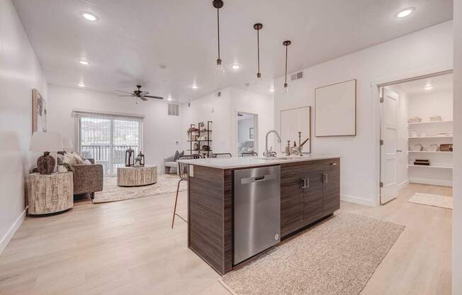 a kitchen with an island in the middle of a living room