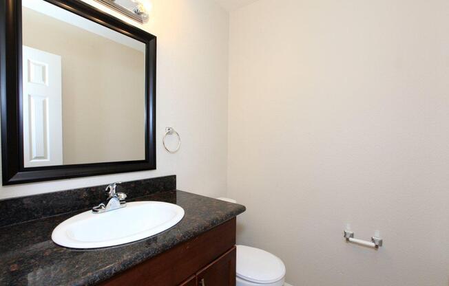 a white sink and a mirror