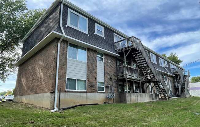 a brick apartment building with stairs on the side of it