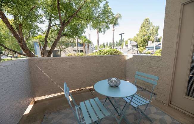 A patio with a table and two chairs at Autumn Oaks Apartments, Roseville, CA, 95678