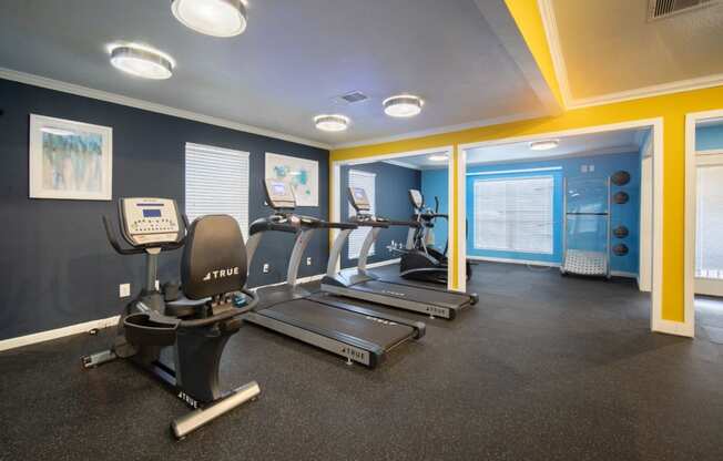 a gym with treadmills and other exercise equipment