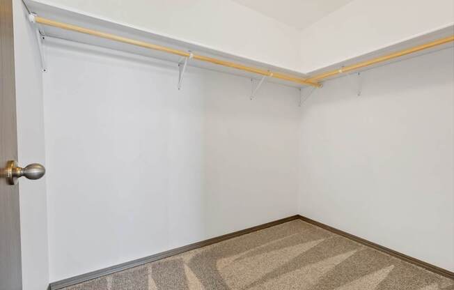 A room with a door and a carpet on the floor.