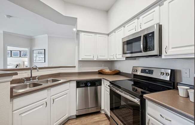 Modern and upgraded kitchens with wood-style flooring - Grand Centennial Apartments