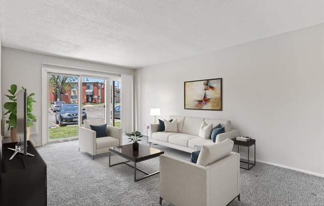 the living room of an apartment with a couch and chairs