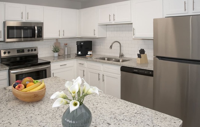 a kitchen with granite counter tops and stainless steel appliances