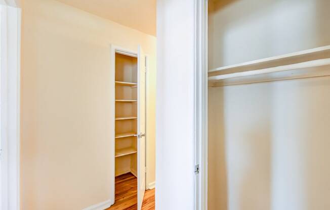 bedroom closet with shelving and view of hallway closet at garden village apartments in congress heights washington dc