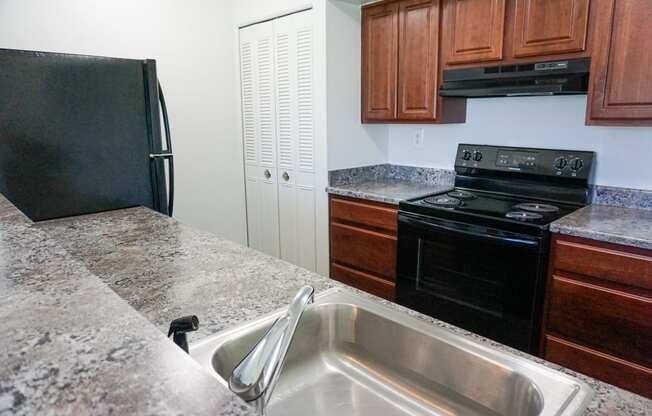 Fully Equipped Kitchen with granite counter tops at Woodcrest Apartments in Westland, Michigan