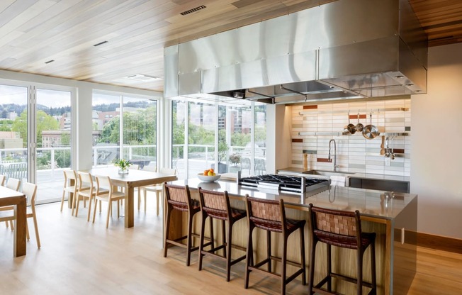 the kitchen and dining area of a modern house with a large kitchen island and chairs at Slabtown Square Apartments, Oregon