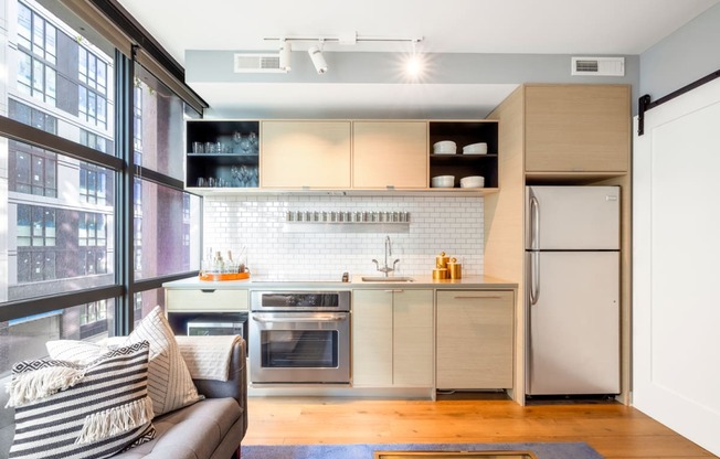 a small kitchen with a window and a couch