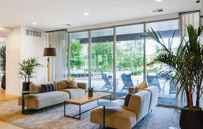 A living room with a large window and a couch.