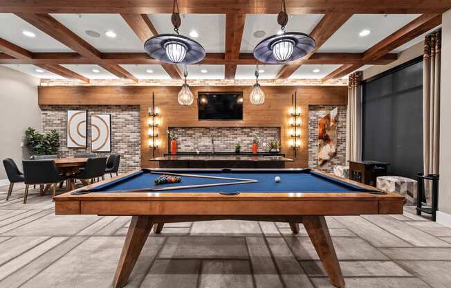 a games room with a pool table and a fireplace