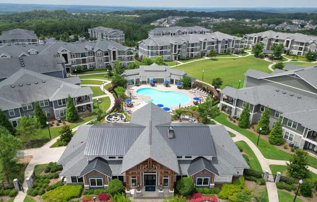 an aerial view of a large complex with a swimming pool and golf course