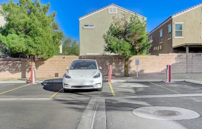 A white car is parked in a parking lot.