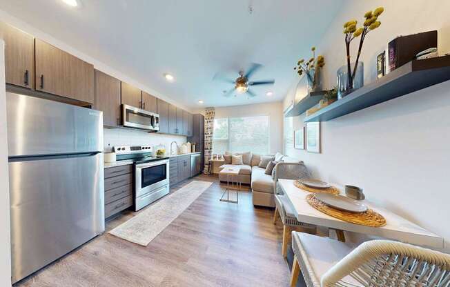 A modern kitchen with stainless steel appliances and wooden cabinets.