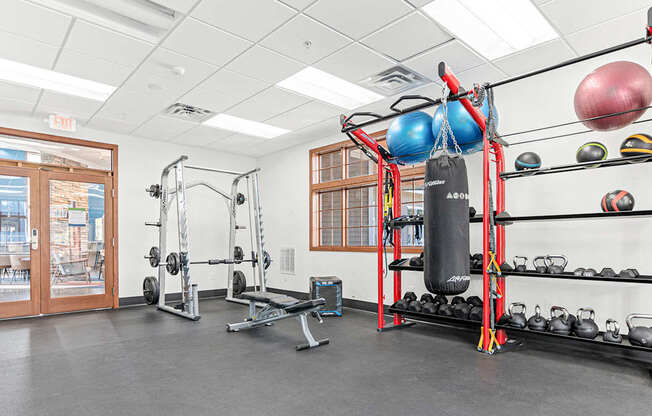 the gym with weights and other equipment at the monarch apartments in des plaines