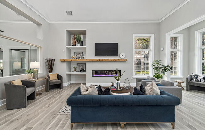 Community Clubhouse with Lounge Furniture and Fireplace at Bridges at Oakbend Apartments in Lewisville, TX.