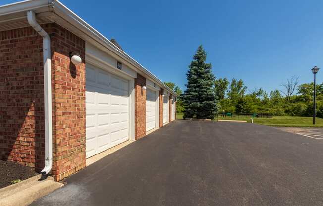 This is a photo of a pond with a fountain and detached garages at Washington Place Apartments in Miamisburg, Ohio in Washington Township.