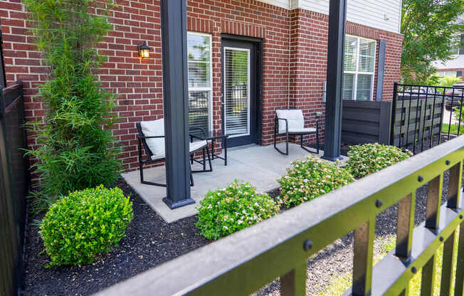 A small patio with a table and chairs.