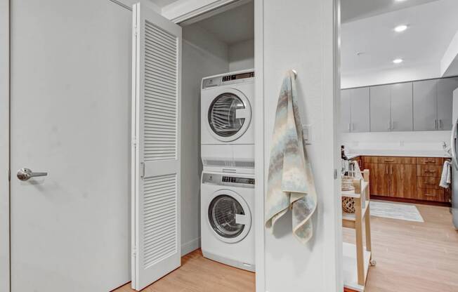 a small laundry room with a washing machine and a door