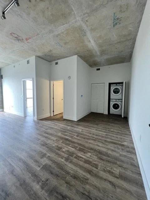 a empty living room with white walls and a washing machine