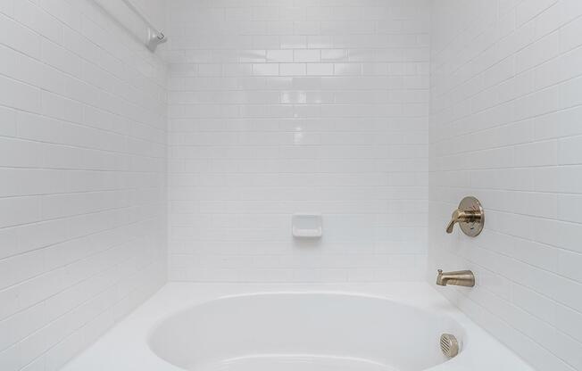 a white tub sitting next to a sink