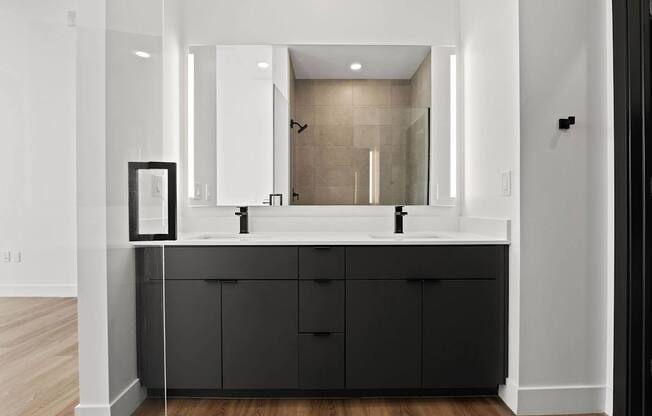 A bathroom with a large mirror and a sink.