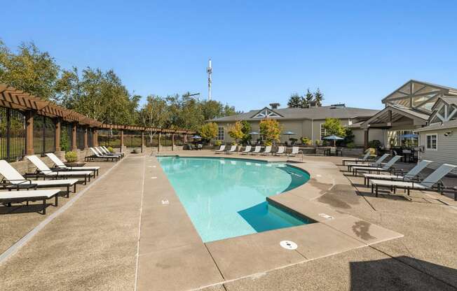 the resort style pool is surrounded by lounge chairs and umbrellas