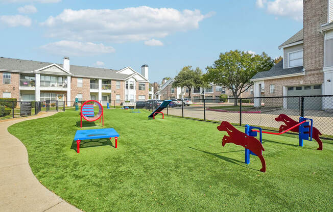 A playground with a red horse and a blue bench.