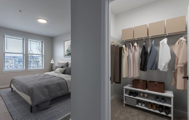 a walk in closet in a bedroom with a bed and a window