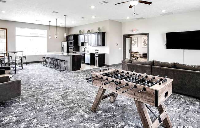 a games room with a foosball table and couches