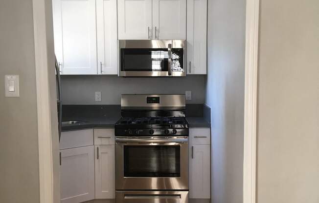 Kitchen view of microwave and stove