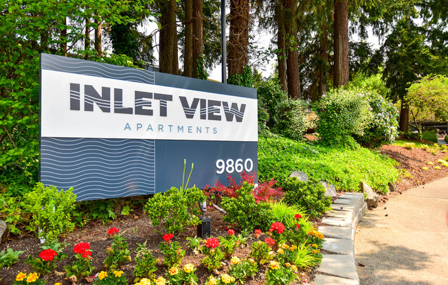 a sign at the entrance to the inlet view apartments