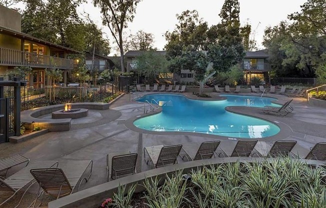 a large swimming pool with chairs around it