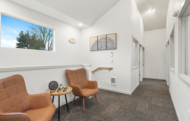 A living room with two chairs and a table.